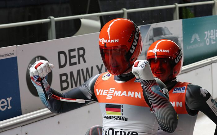 Toni Eggert (left) and Sascha Benecken from Germany celebrate as they cross the finish line at the Alpensia Sliding Center in Pyeongchang, Gangwon-do Province, where the Viessmann Luge Team Relay World Cup took place on Feb. 19.